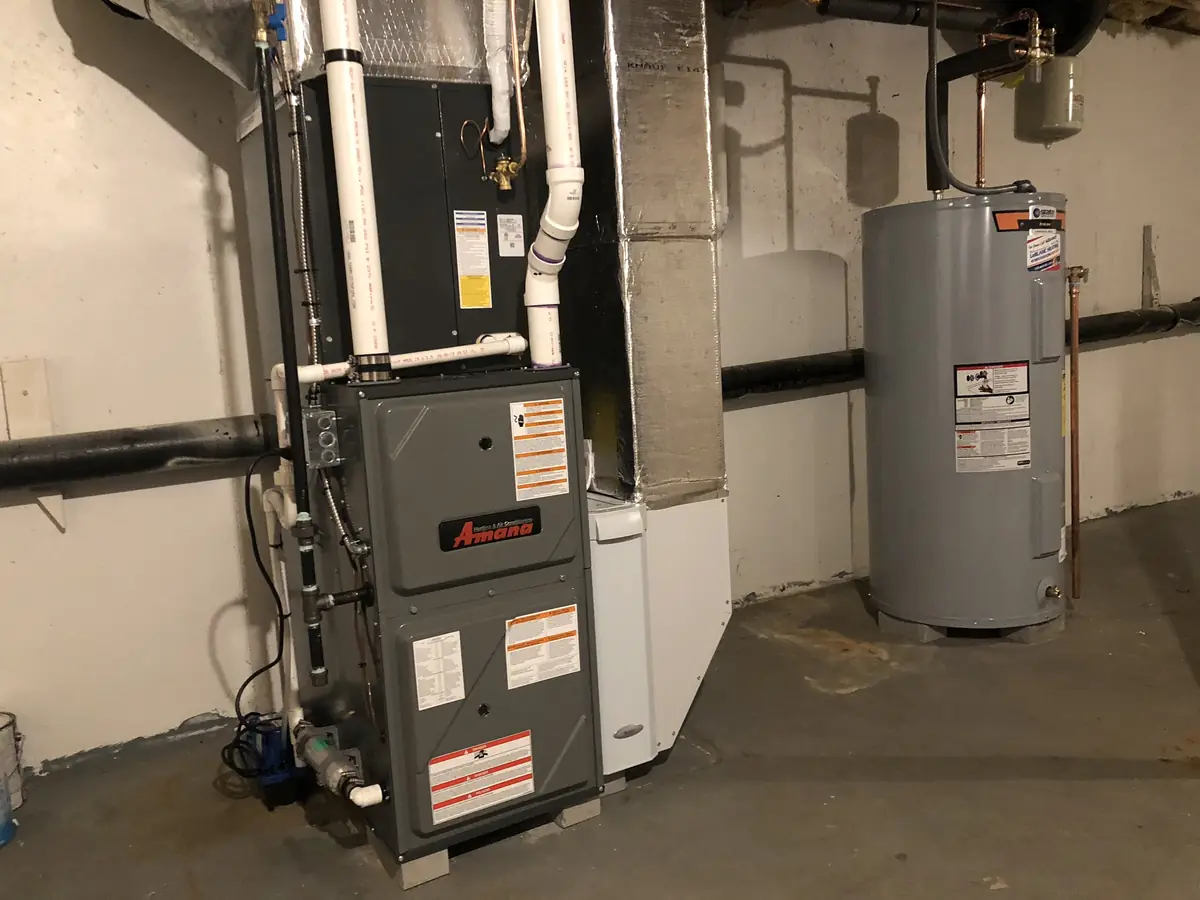 Amana gas furnace installation in a Southern NH basement with insulated supply plenum and combustion-air piping by A.J. LeBlanc Heating