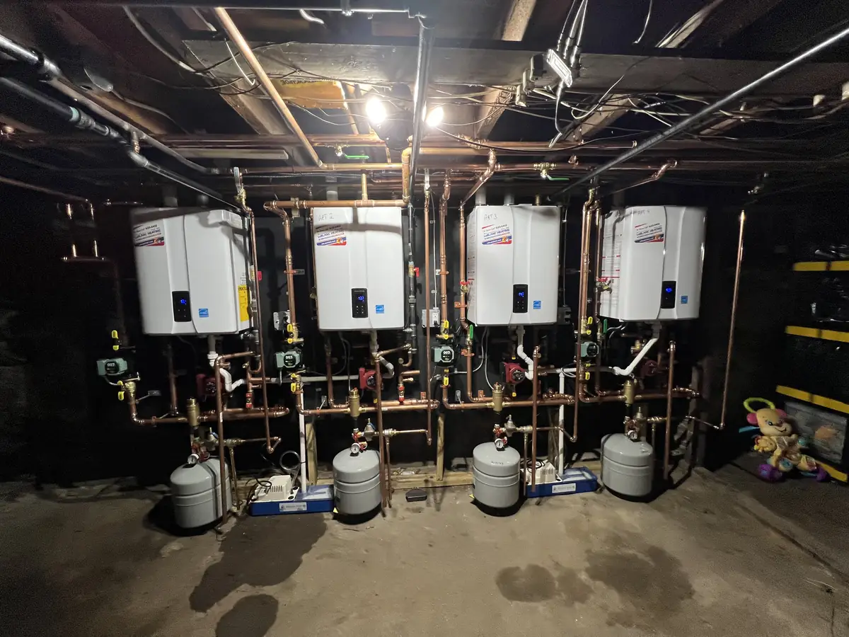 Four Navien tankless water heaters in a cascade installation by A.J. LeBlanc Heating in Southern NH