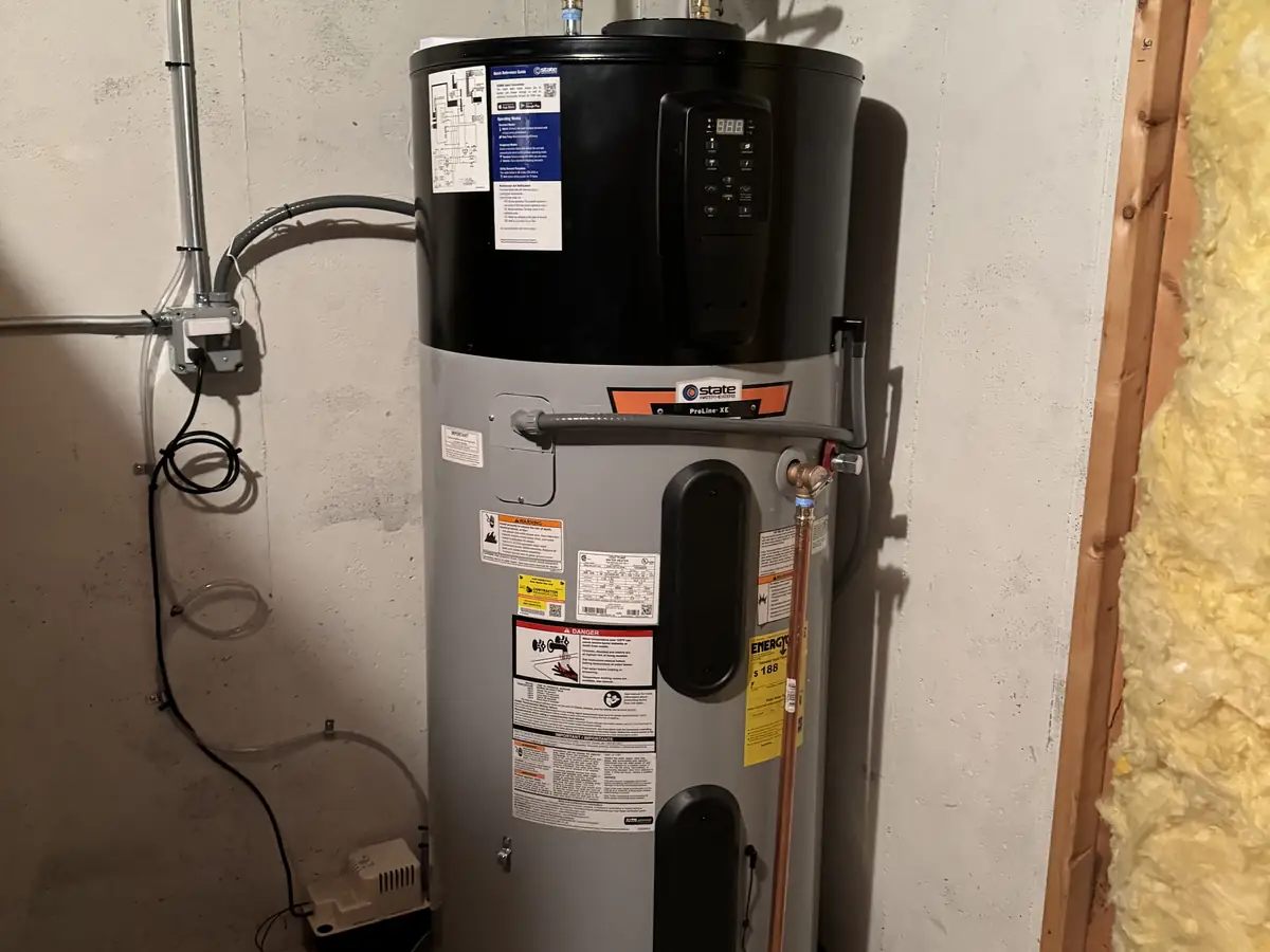 Hybrid heat pump water heater installation by A.J. LeBlanc Heating licensed plumbers in a Southern NH basement