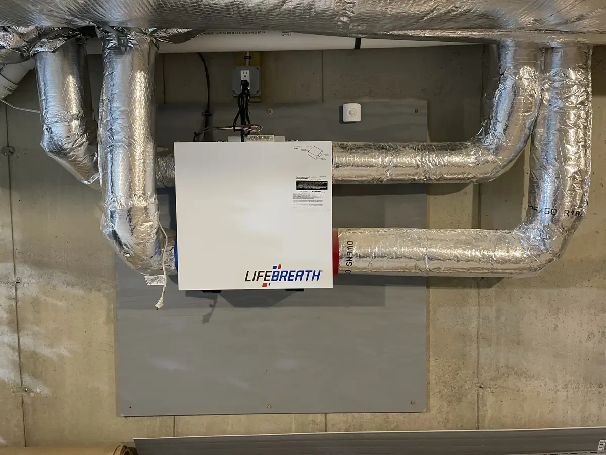 Lifebreath ERV ventilator with insulated supply and exhaust ductwork installed in a Southern NH basement by A.J. LeBlanc Heating